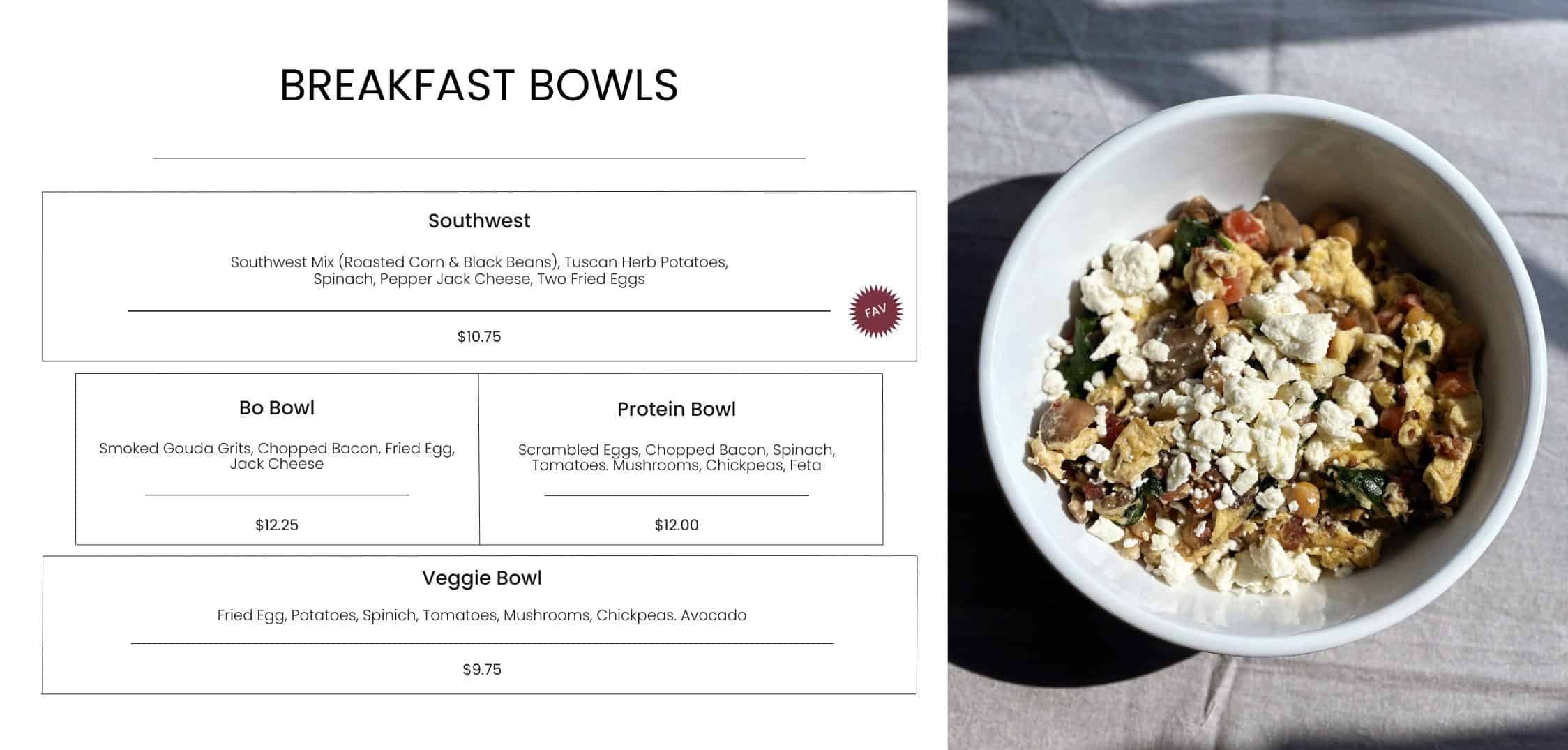 Delicious breakfast bowl with scrambled eggs, bacon, spinach, tomatoes, mushrooms, and feta cheese served in a white bowl on a textured surface.