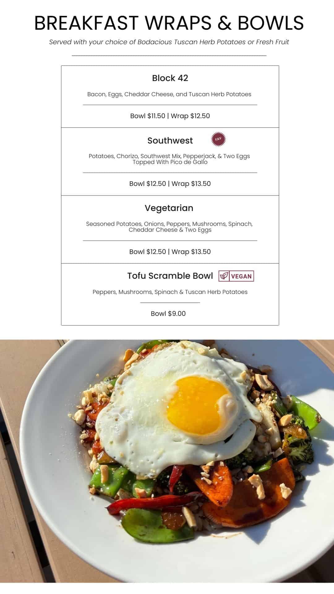 Scrambled egg and vegetable breakfast bowl with peppers, broccoli, and a fried egg on top, served with a side of fresh vegetables, perfect for a nutritious meal.