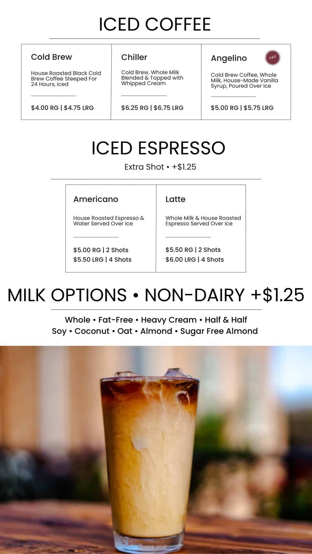 Up of a tall iced coffee drink at Café Janesville, featuring creamy milk and coffee layered in a clear glass, perfect for a refreshing beverage.
